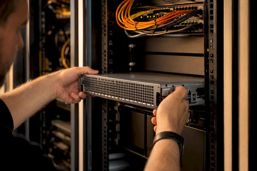 Hands securing network device in data center