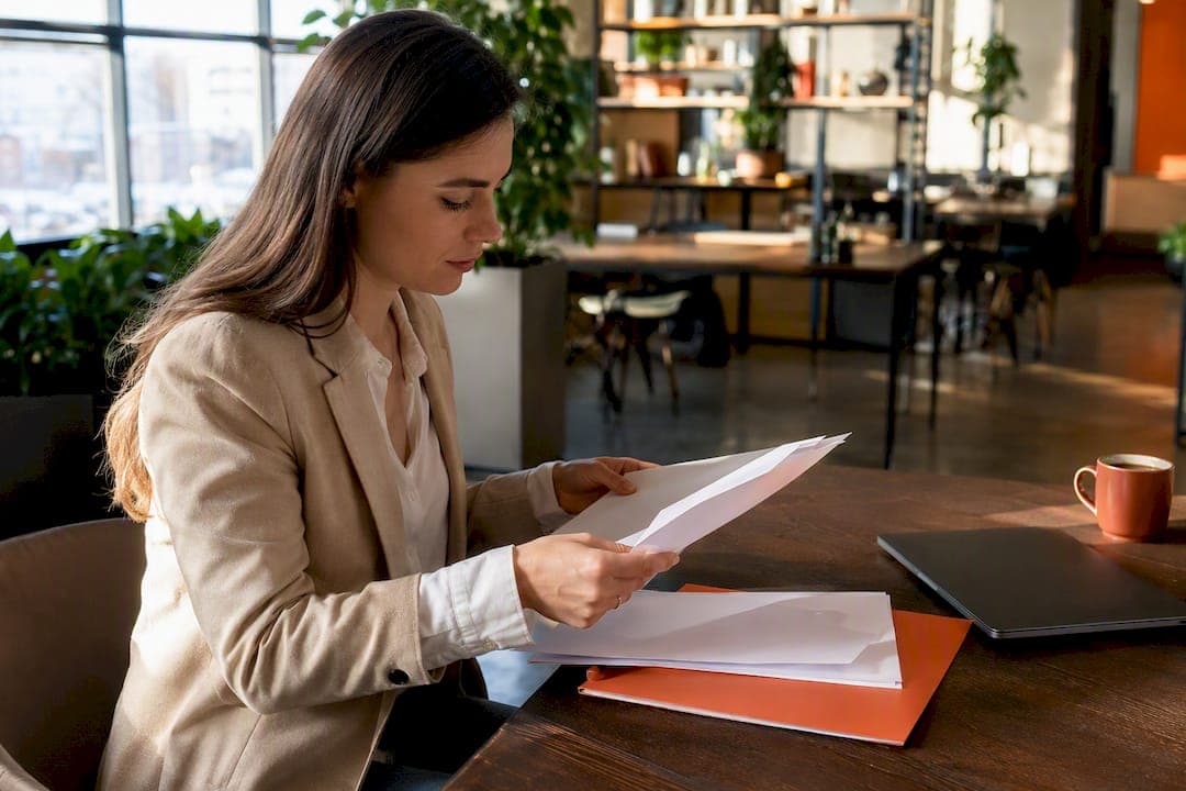 Hands adjusting vendor onboarding folder