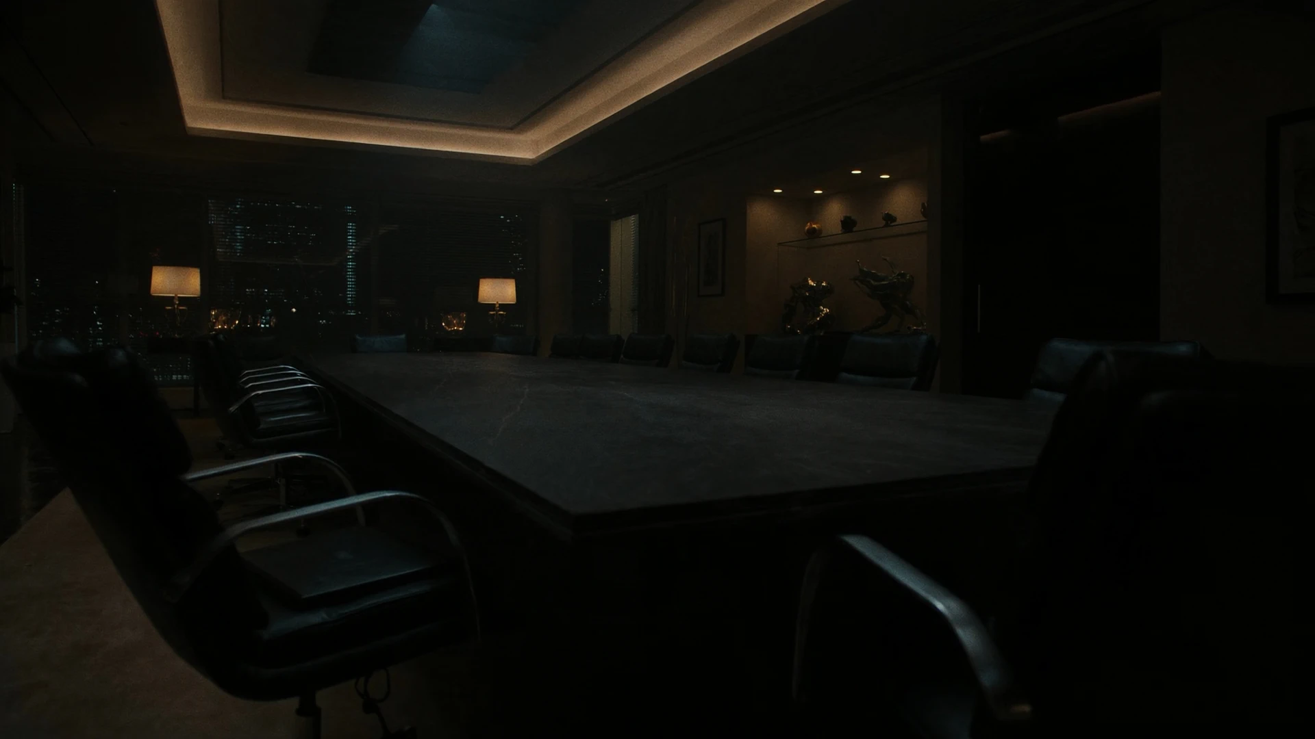 After-hours conference table, low angle, chairs waiting for a rights decision