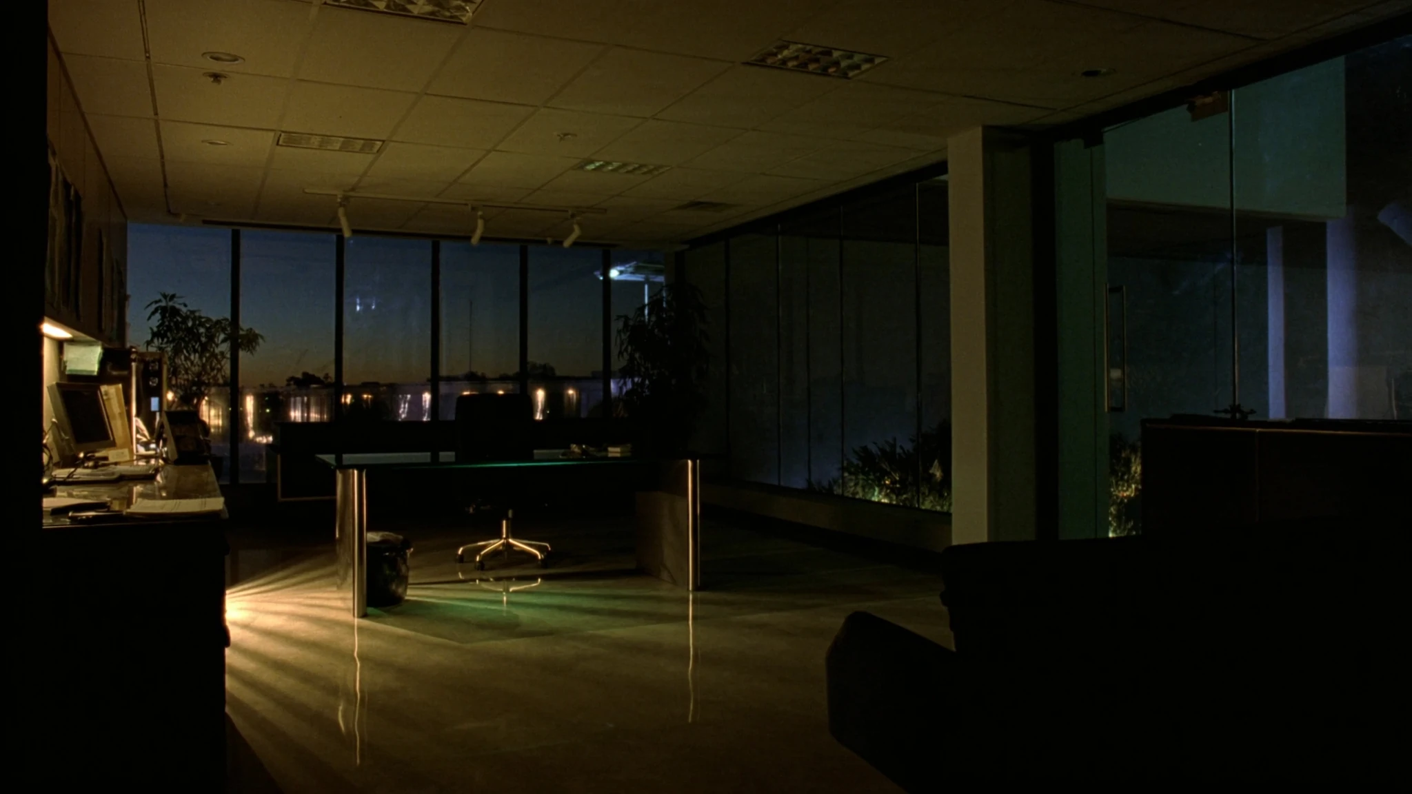 After-hours corridor in an automotive headquarters, a single chair outside the rooms where the AI function is decided