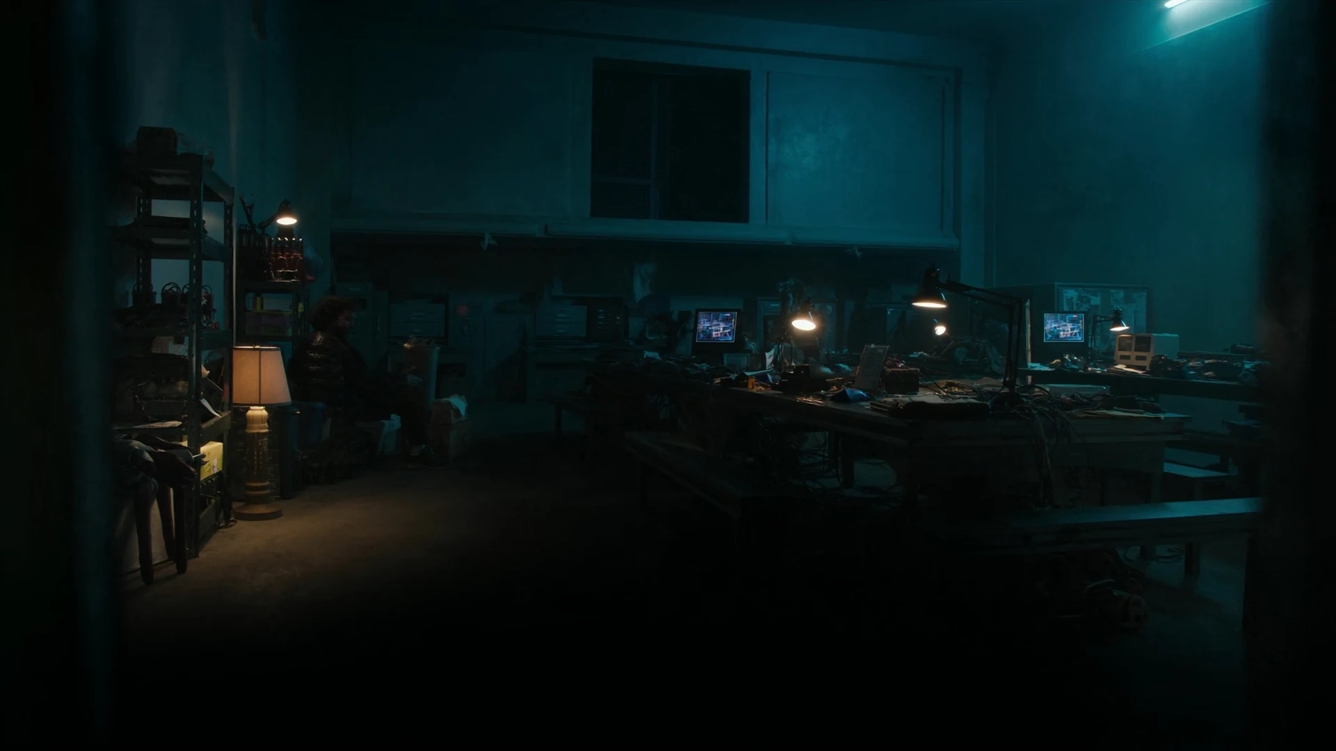 After-hours standards lab, warm lamps over benches in a teal room