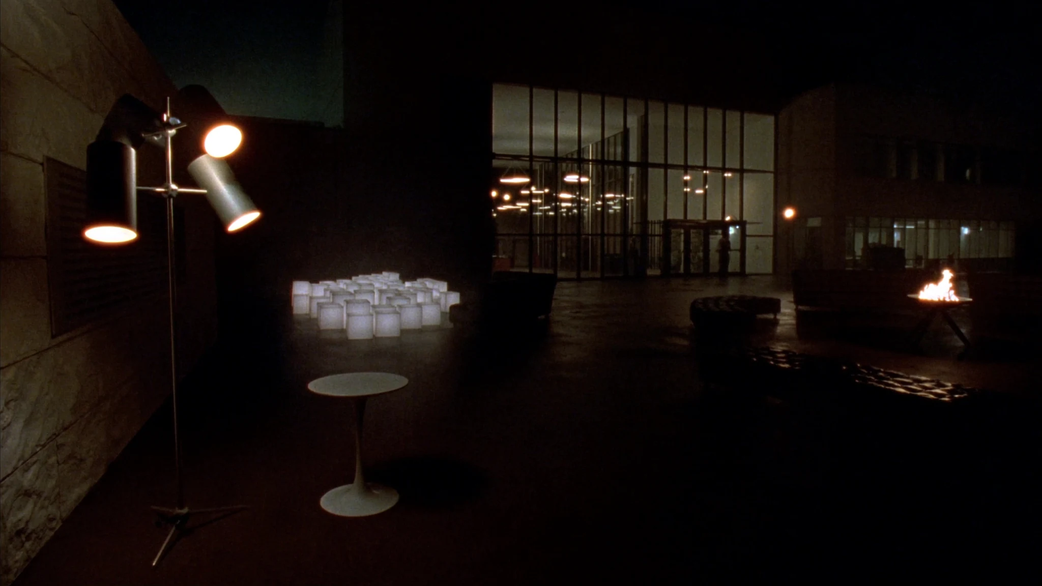 Night view into an energy headquarters lobby, a corridor of warm light toward the rooms where decisions are made