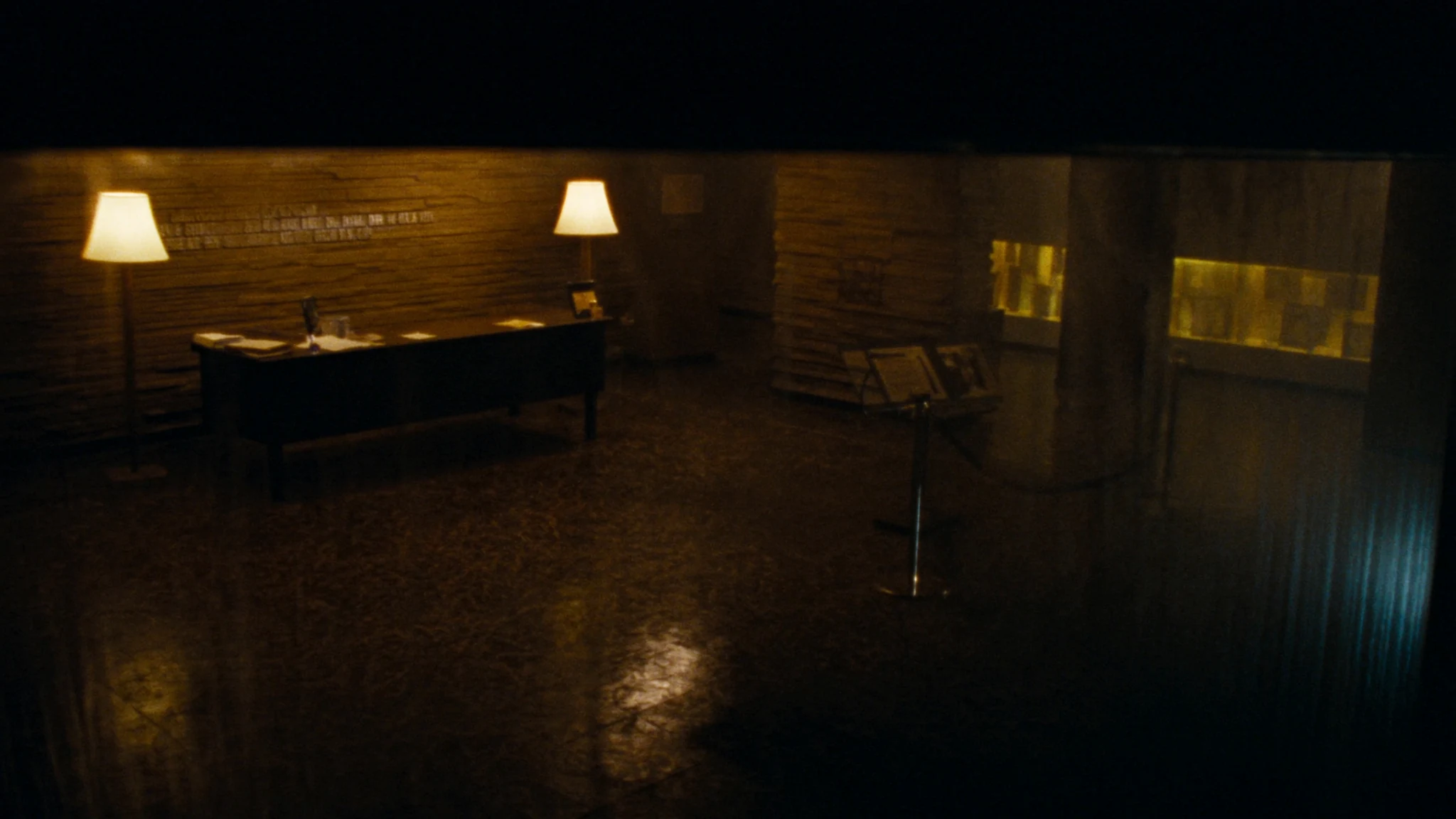 Night view into a civic lobby, a corridor of warm light toward the rooms where decisions are made