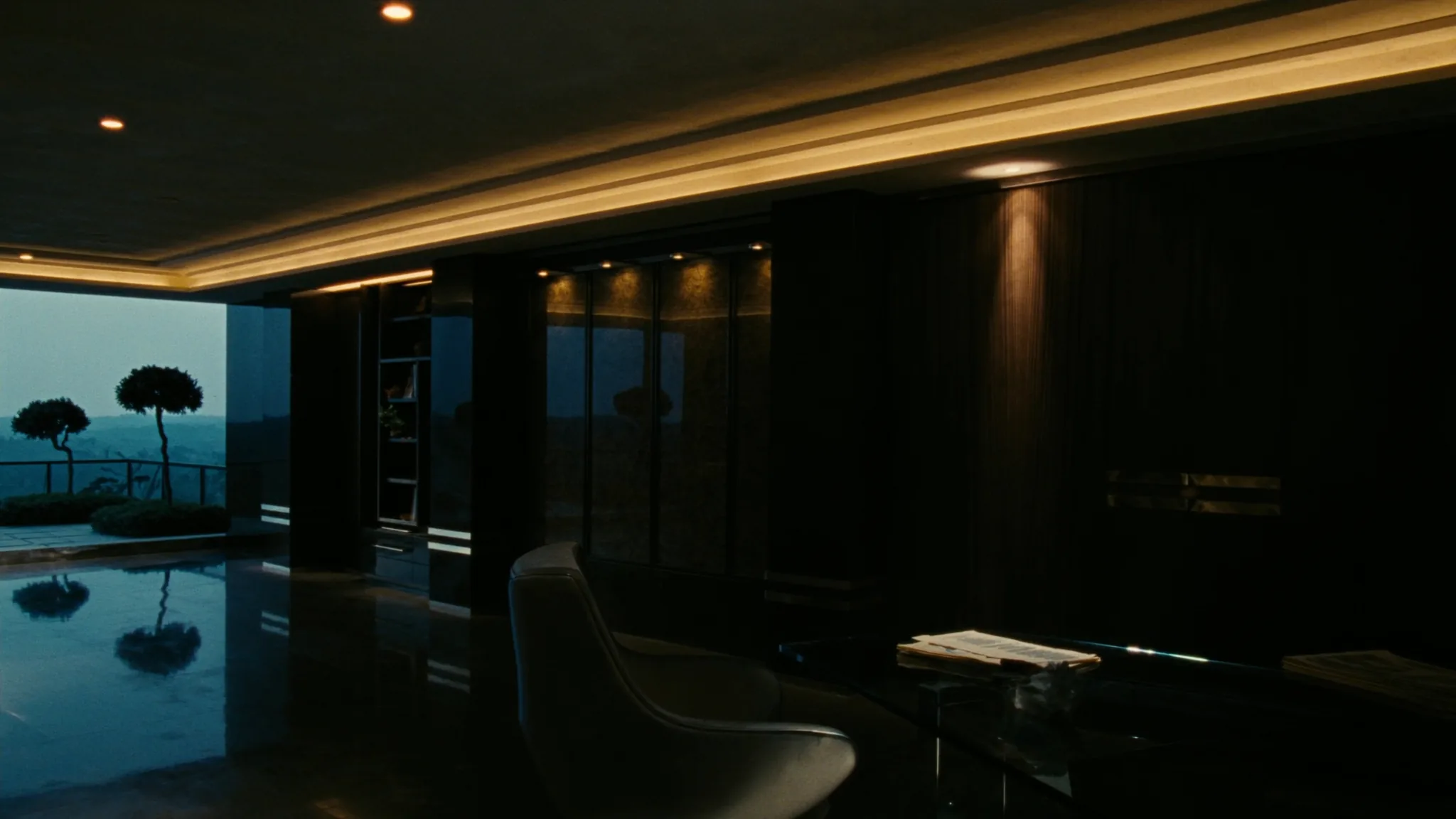 After-hours corridor in a hospitality headquarters, a single chair outside the rooms where the AI function is decided