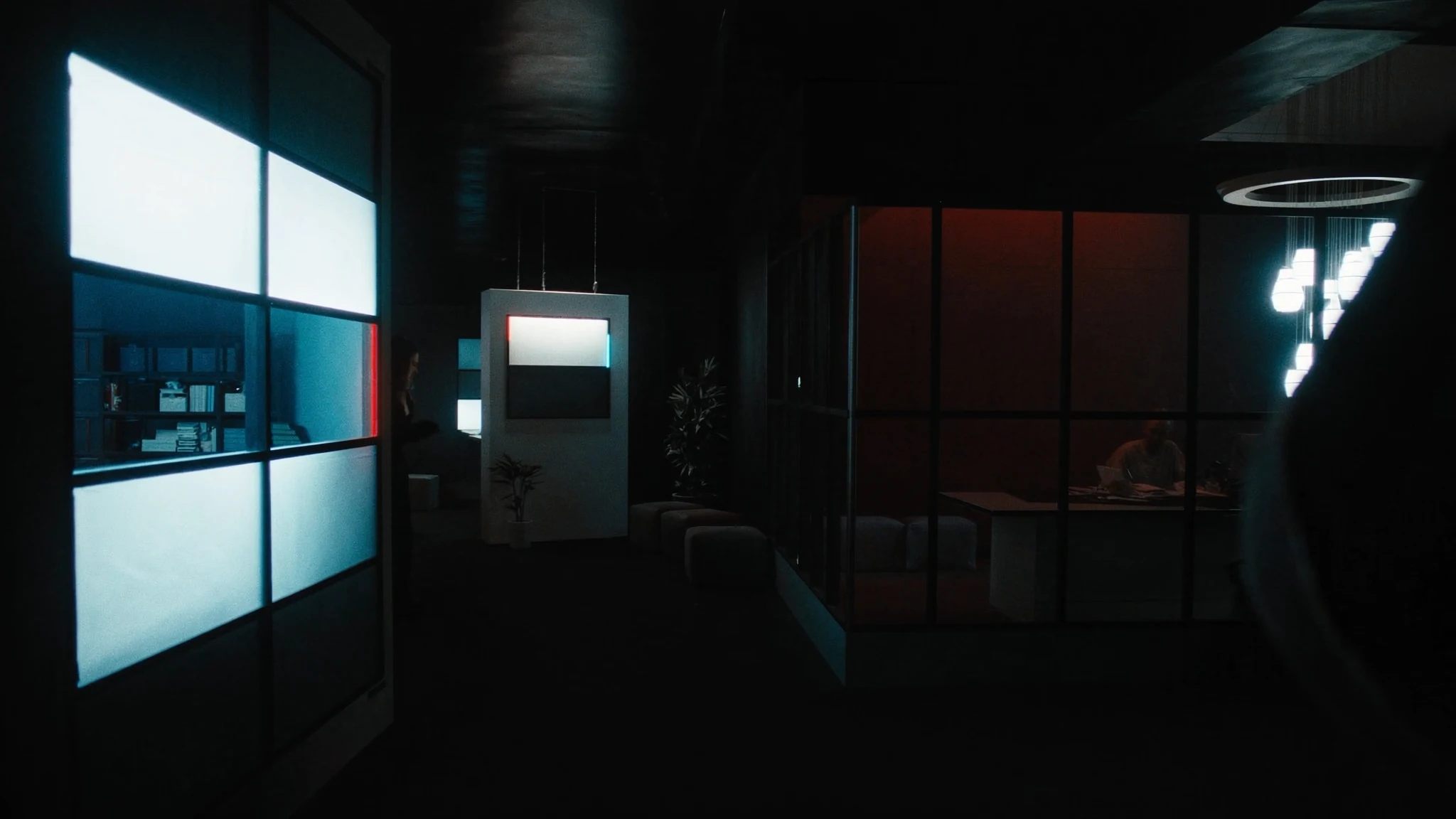 After-hours corridor in an insurance headquarters, a single chair outside the rooms where the AI function is decided