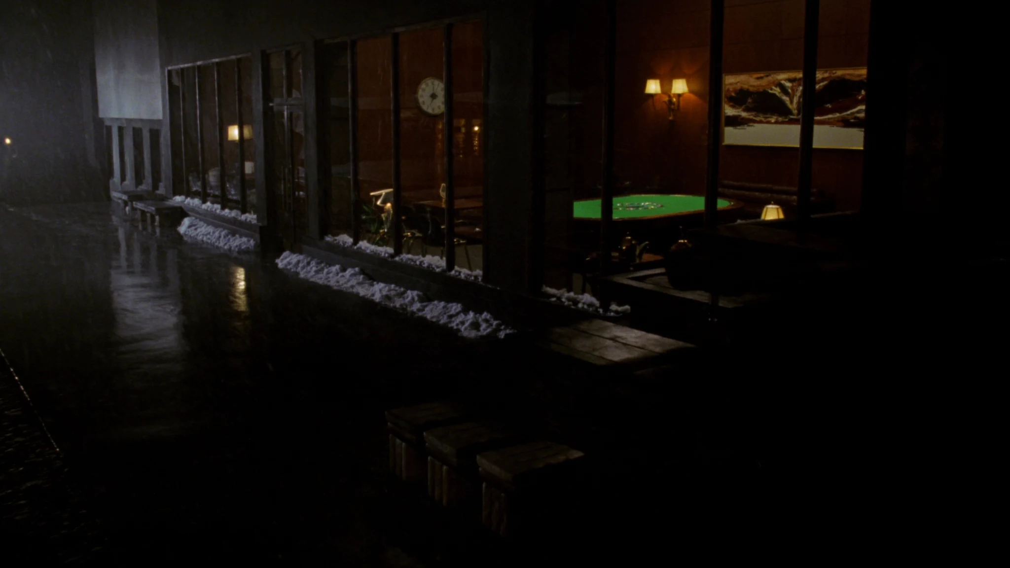 Night view into an insurance headquarters lobby, a corridor of warm light toward the rooms where decisions are made