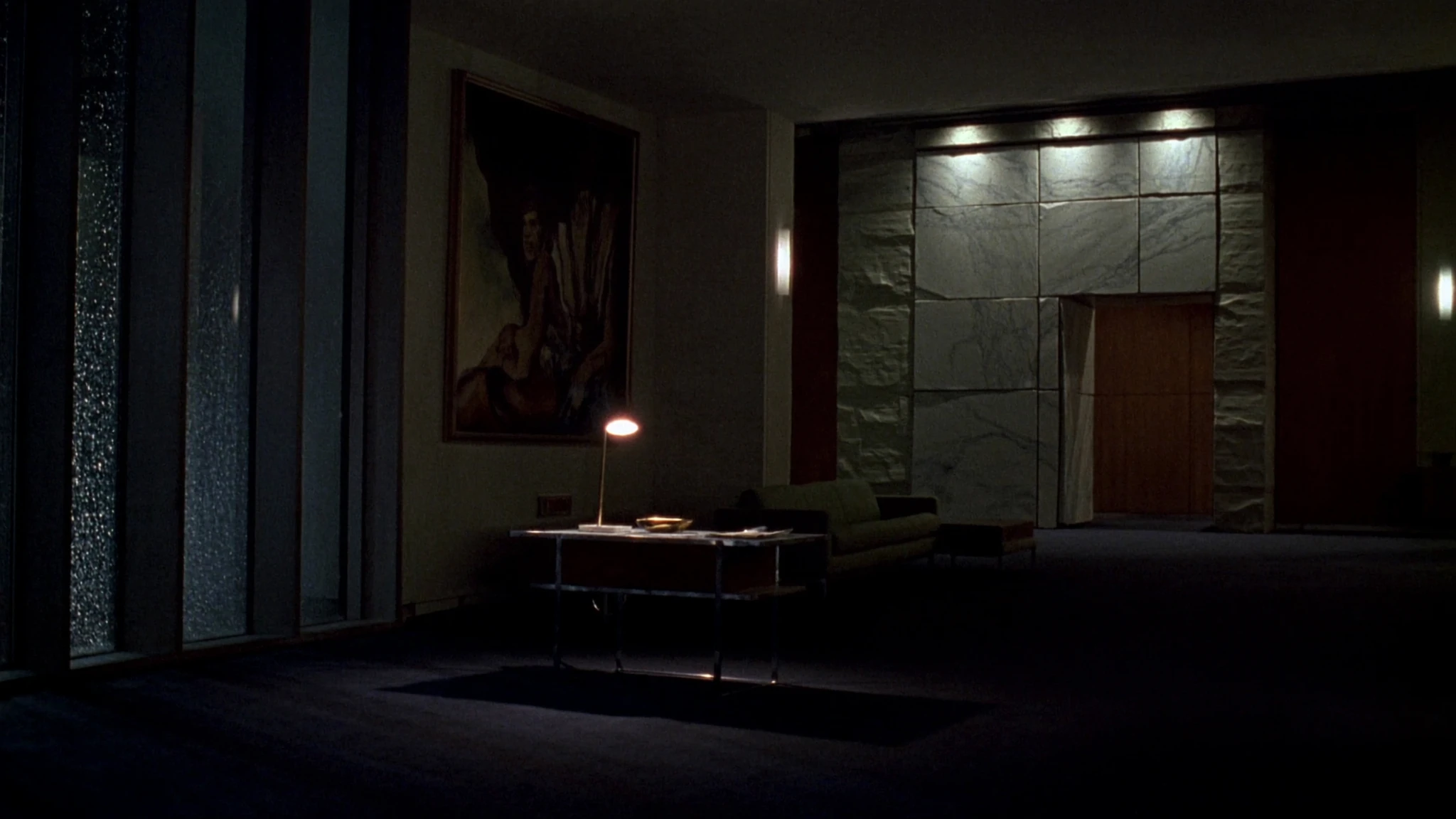 Night view into a law-firm lobby, a corridor of warm light toward the rooms where decisions are made