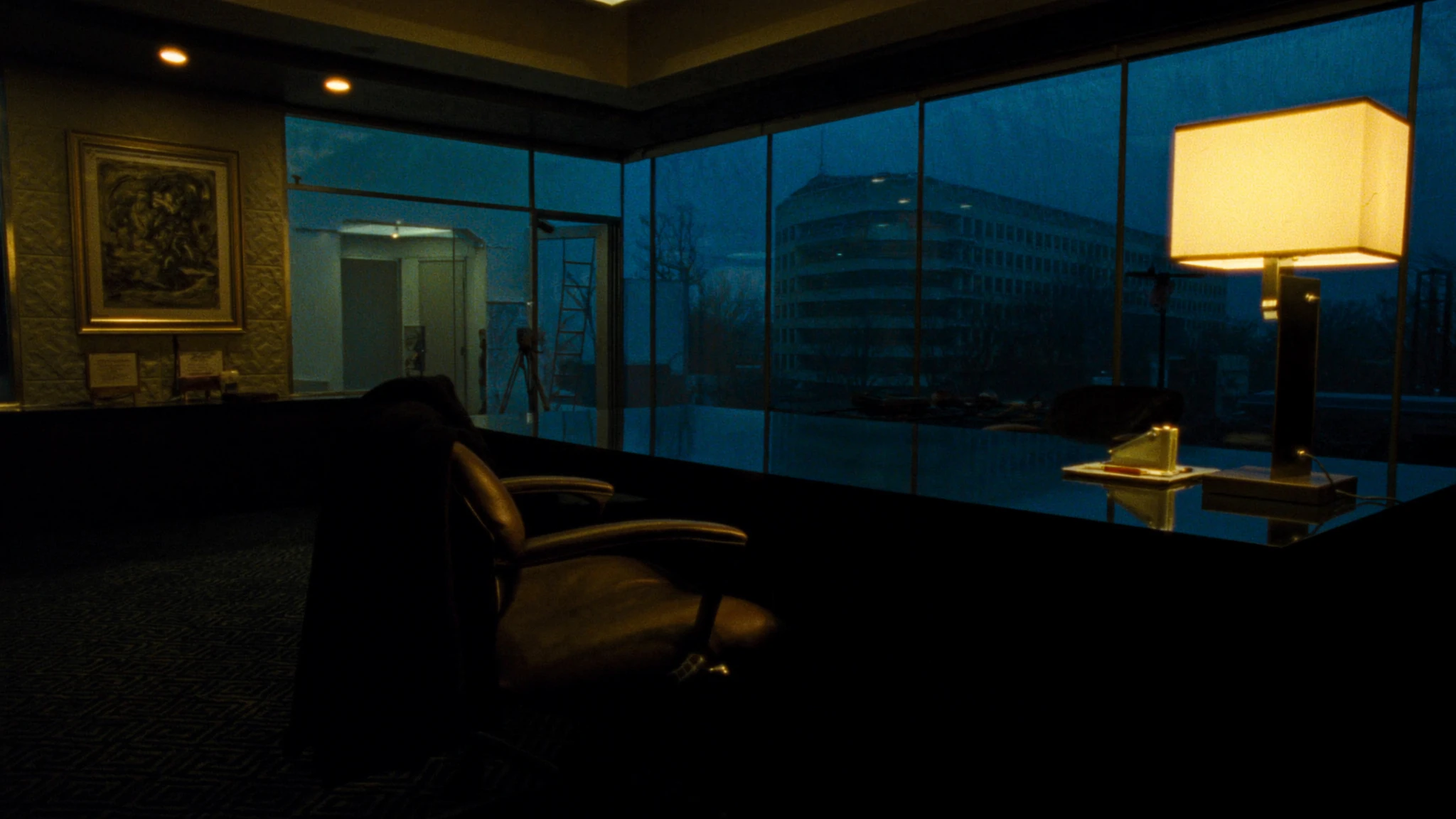 After-hours corridor in a pharmaceutical headquarters, a single chair outside the rooms where the AI function is decided