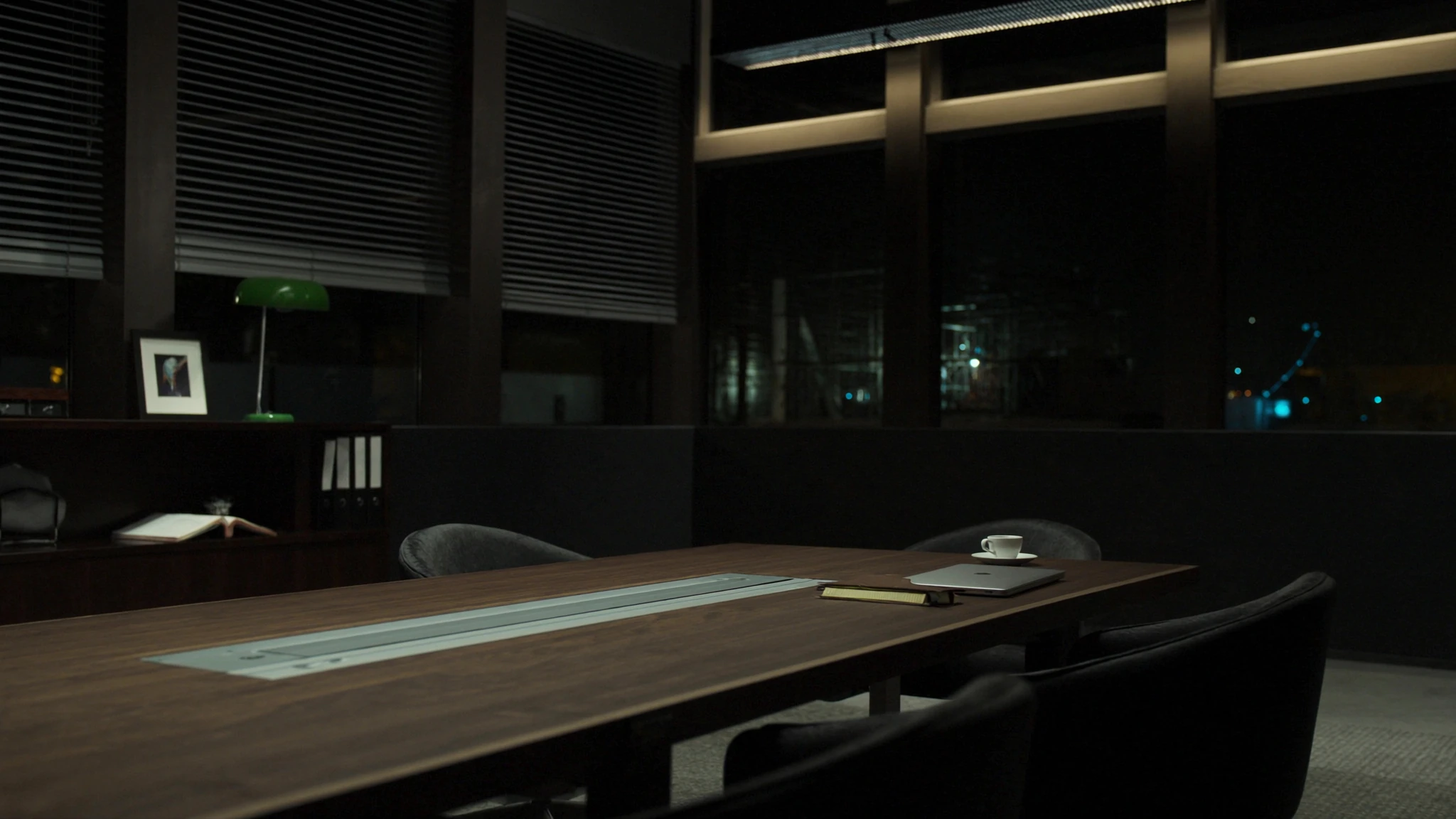 After-hours conference table in a developer office, laptop and espresso waiting for a decision that has no owner